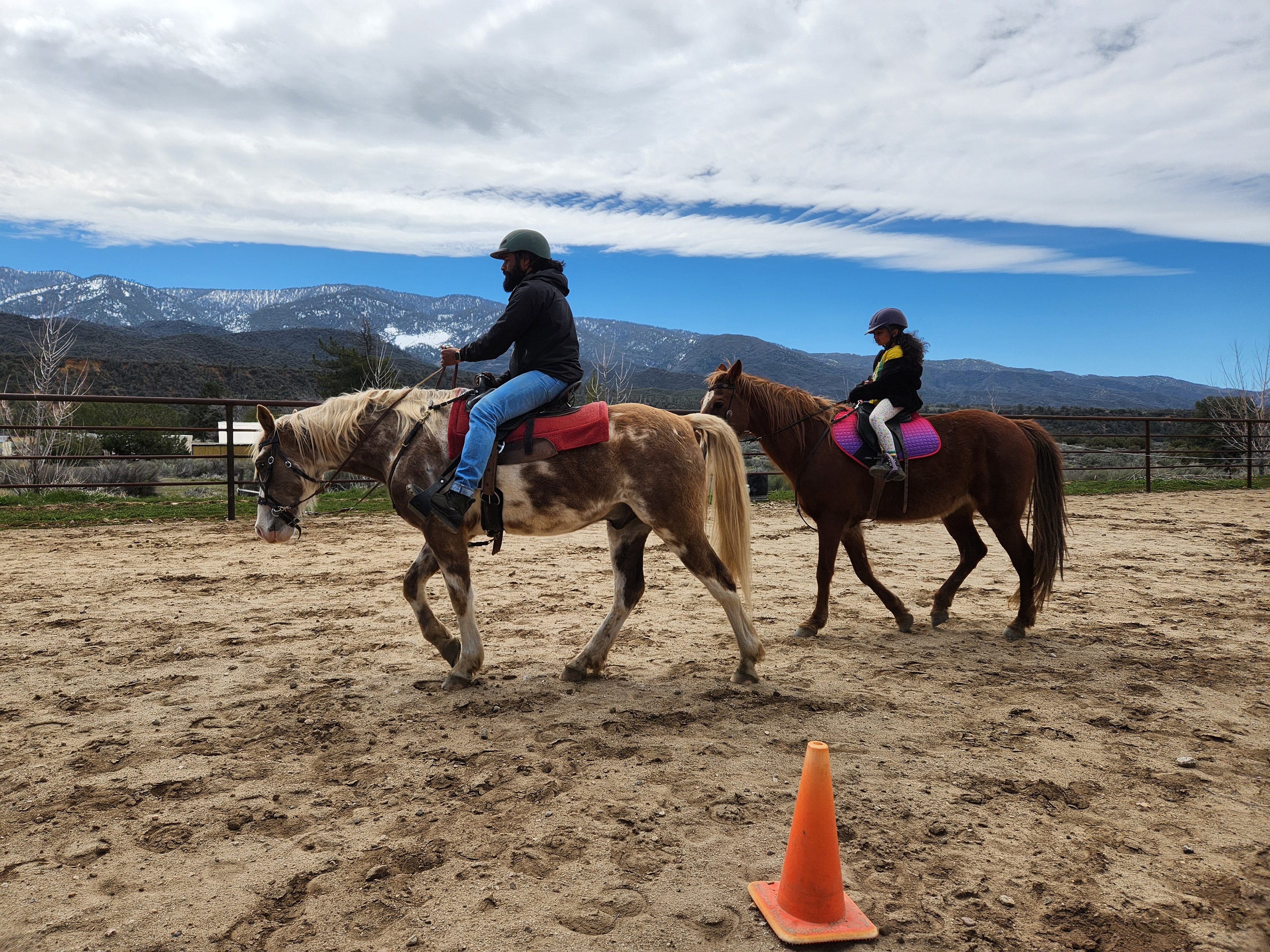 Group riding lesson with mountain backdrop